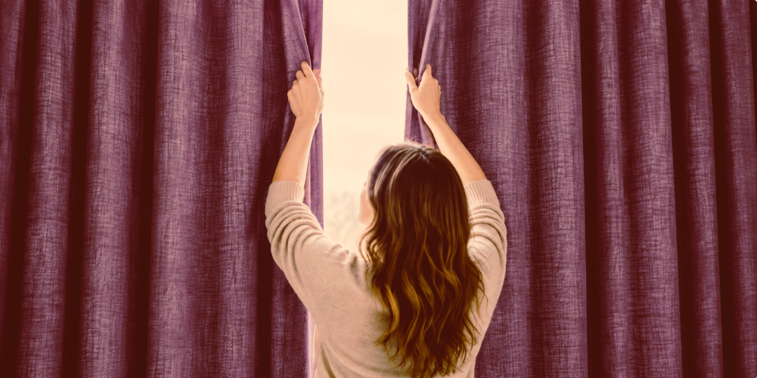 A woman drawing the curtains closed